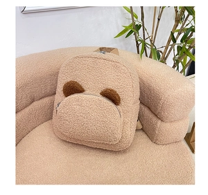 Detail of plush teddy fleece backpack featuring cute brown bear ears and front pocket
