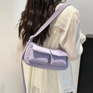 Minimalist light purple crossbody cylinder bag with adjustable strap and front pockets