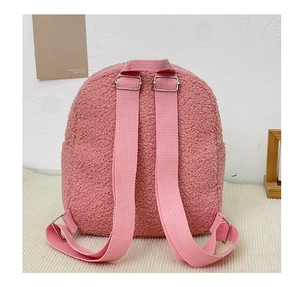 Detailed back view of pink plush backpack showing teddy fur texture and adjustable straps