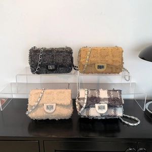 Elegant denim and tweed crossbody bags with chain straps and metal locks in four colors