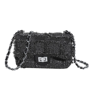 Fashionable black tweed shoulder bag with fringe edges and silver chain strap