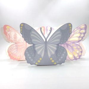 Detail of laser-cut paper butterfly gift boxes in pink, purple and grey shades
