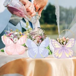 Butterfly party favor boxes in pink, blue, and purple for wedding flower decorations