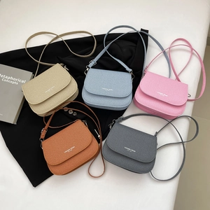 Five assorted colors of corduroy saddle crossbody bags featuring trendy minimalist design