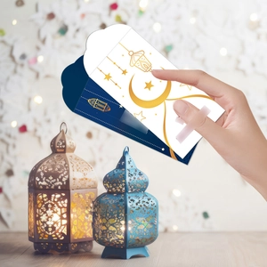 Macro detail of navy and white Ramadan envelopes with gold moon and lantern patterns