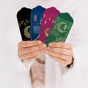 Detail of Eid Mubarak money envelopes with gold foil crescent and lantern patterns