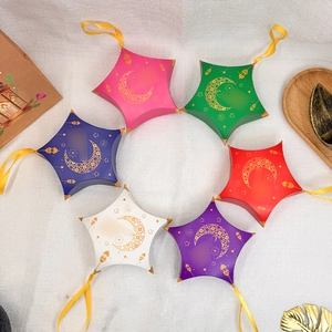 Star-shaped Eid gift boxes in colorful colors with gold moon and lantern patterns