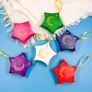 Detail of colorful star-shaped paper favor boxes with golden moon and star patterns