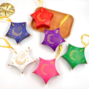 Six star-shaped festive gift boxes with gold moon and mosque patterns and yellow ribbons