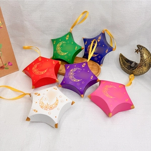 Detailed view of colorful star-shaped gift boxes with gold moon and star patterns