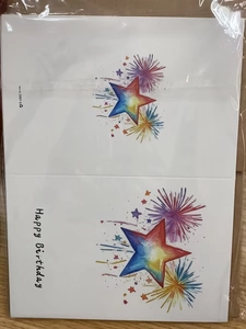 Detail of watercolor star pattern and Happy Birthday calligraphy on card with envelope
