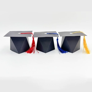 Macro shot of doctoral cap candy boxes with assorted vibrant red, blue, and gold tassels