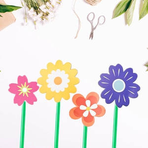 Detailed view of creative flower pens with colorful silicone heads and green stem design