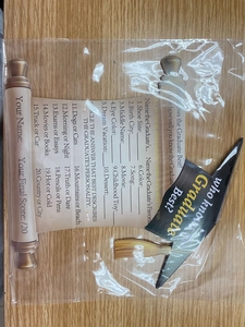Detail of graduation party game cards with doctoral cap and scroll designs on wood background