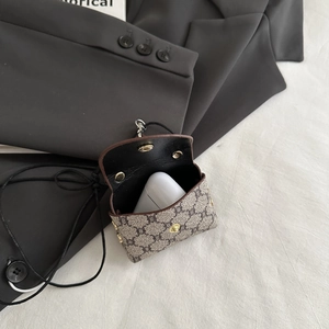 Detail of monogram canvas mini pouch with metal snap closure and detachable lanyard strap