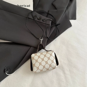 Detail of a mini neck pouch with vintage brown monogram print and brown leather trim