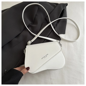 Detail of white mini saddle bag with slanted flap and Fashion Trend printed text