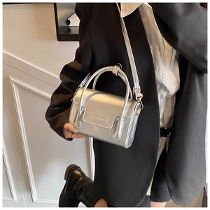 Close-up of metallic silver mini bag with structured top handle and stylish crossbody strap