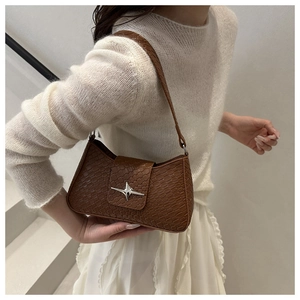 Detail showing brown faux crocodile leather texture and silver star metal buckle
