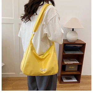 Detailed shot of bright yellow tote bag with FASHION BAG label and sturdy shoulder strap