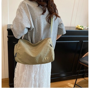 Détail du grand sac messager en nylon avec bandoulière réglable et imprimé FY