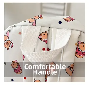 Detail of comfortable woven top handle on a cute cartoon pattern backpack for students