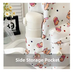 Detail of the side storage pocket on a cute white backpack holding a water bottle