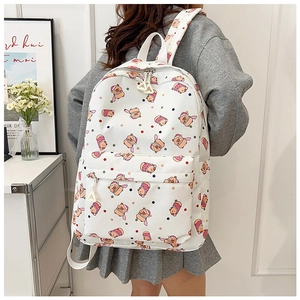 Detail view of white backpack with cute bear prints and high-capacity storage compartments