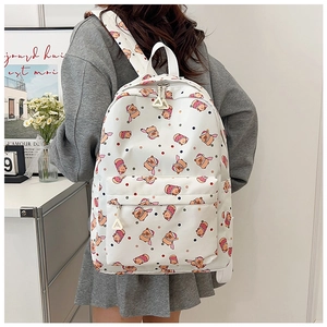 Detailed view of the cute white backpack with cartoon bears and large capacity main compartment
