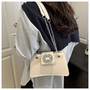 Fashionable cream leather shoulder bag with crystal buckle and silver chain strap