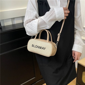 Minimalist straw woven Boston handbag with leather trim and shoulder strap for summer