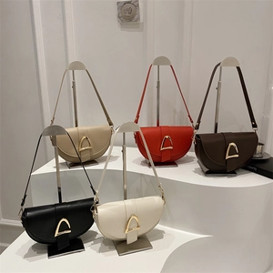 Minimalist vintage saddle shoulder bag in five colors with iconic gold triangle buckle