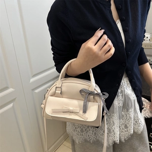 Chic cream white crossbody bag with checkered ribbon bow for elegant spring outfits