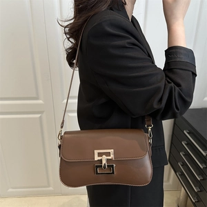 Minimalist brown leather shoulder bag with gold geometric buckle for elegant women