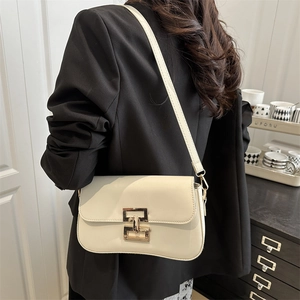 Chic cream white square shoulder bag with gold clasp shown on a black suit blazer