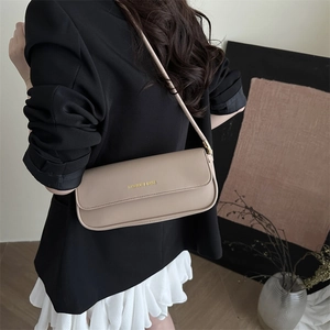Beige faux leather baguette shoulder bag with gold text and minimalist strap for women