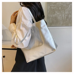 Detail of silver metallic tote bag with large capacity and textured PU leather surface
