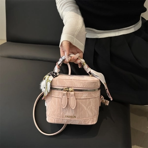 Pink marble pattern structured handbag with decorative silk scarf and plush pompom charm