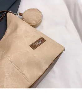 Detail of khaki tote bag with suede texture and a small detachable round coin purse