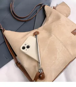 Detail of camel tote bag with front zipper pocket and round coin purse attachment