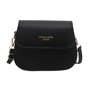 Minimalist black leather saddle crossbody bag with gold lettering and metallic hardware
