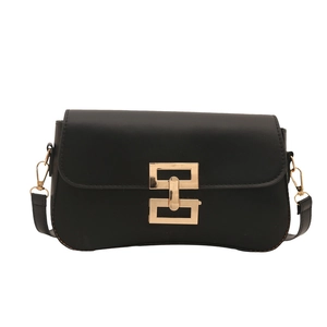 Minimalist black flap shoulder bag with a bold gold metal interlocking buckle and strap