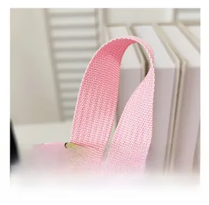 Detailed shot of pink reinforced nylon handle and stitch work on kids cow backpack