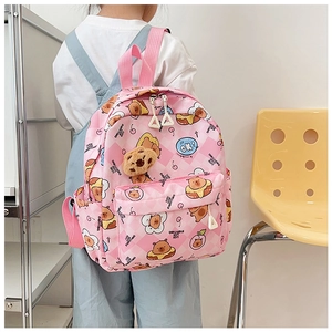 Toddler girl wearing pink checkered cartoon backpack with cute bear pendant and patterns