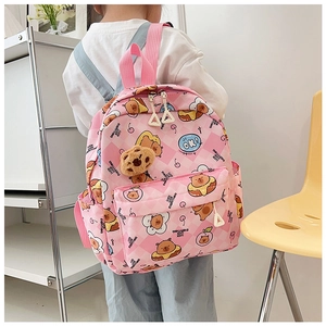 Detail of pink plaid kids backpack with cartoon bear prints and plush pendant charm