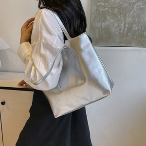 Minimalist large silver metallic tote bag for women showing glossy texture and spacious design