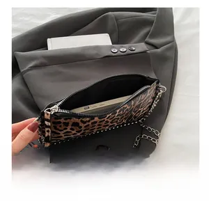 Detail view of the leopard print crossbody bag showing its interior capacity for a smartphone