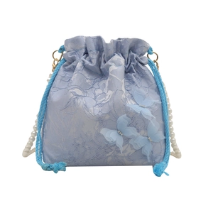 Elegant light blue bucket bag with 3D butterflies and pearl strap on white background