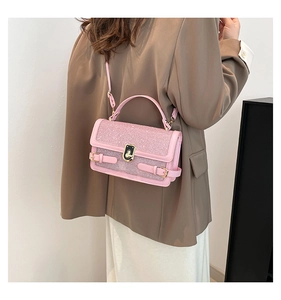 Detailed close-up of pink sequined handbag with gold clasp and elegant carry handle