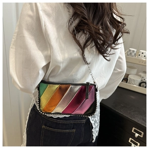 Detail of colorful metallic patchwork crossbody bag with chain strap and silver rivets